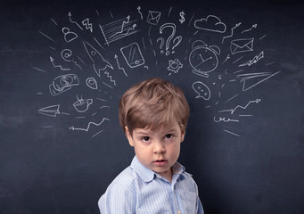 Little boy in front of a drawn up blackboard