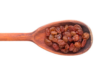 Raisins in a wooden spoon on a white background