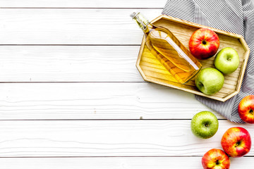 Homemade cider from ripe apples. White wooden background top view copy space