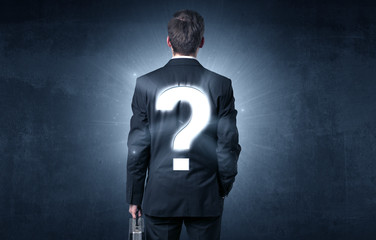 Man standing with question mark on his back