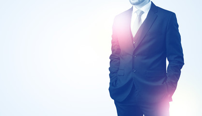 Young businessman standing and thinking