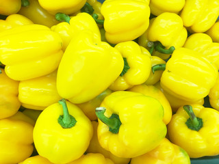 organic yellow bell peppers in market place