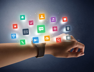 Female hand wearing smartwatch with app icons