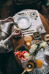 The girl is having breakfast, Girl makes herself a sandwich with a teaspoon, Breakfast of a young girl.