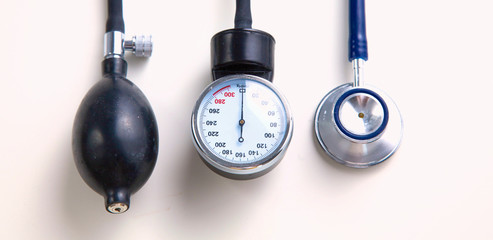 A stethoscope and blood pressure gauge on a white background