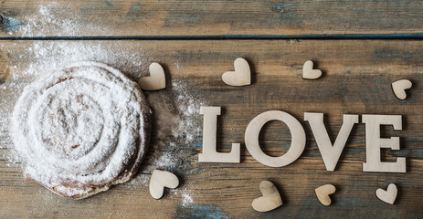 Delicious bun on the wooden background