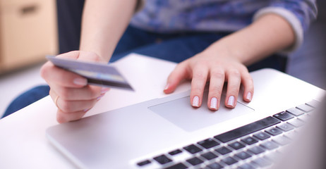 A medical stethoscope near a laptop on table, on white