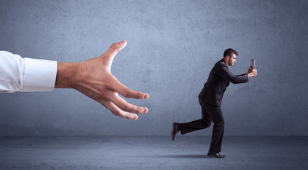 Businessman running from hand