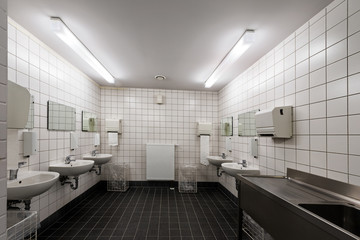 Row of clean sinks and taps in a public toilet