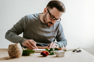 Man wraps present for Women's day.