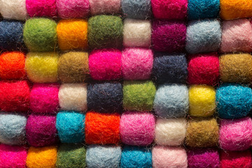Fototapeta na wymiar Felting background: top view of multicolored woolen balls in a row