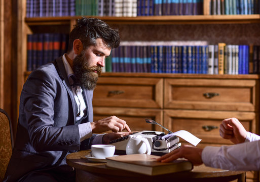 Man in suit or journalist with friend in library.