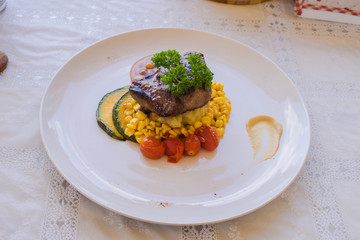 Grilled pork steak and vegetables on dish
