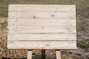 close up of an empty wooden sign on field