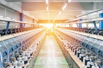 machines for weaving yarns used in industrial factories. Modern technology in spinning yarn.