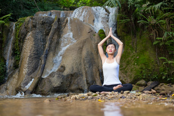 Young woman asia meditates while practicing yoga relax in nature