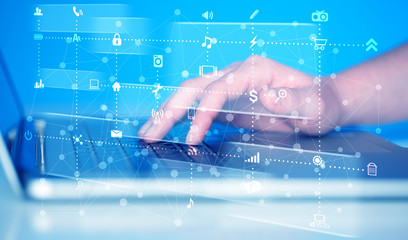 Hand pressing keyboard with high tech media icons