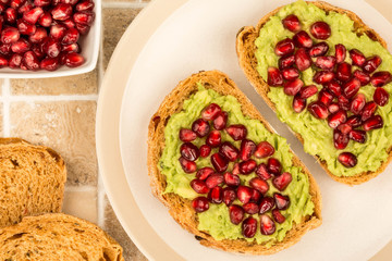 Avocado and Pomegranate Seeds Open Face Sandwich On Mediterranean Bread