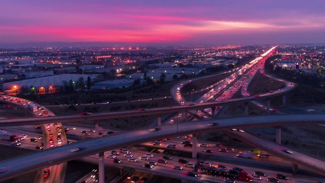 Time lapse of cars on freeway and highway with lights in heavy traffic at sunset