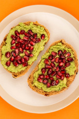 Avocado and Pomegranate Seeds Open Face Sandwich On Mediterranean Bread