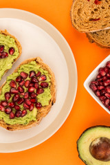 Avocado and Pomegranate Seeds Open Face Sandwich On Mediterranean Bread