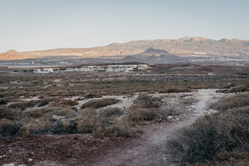 Lonely trail in the desert with the Mountain Teide in the distance in the morning