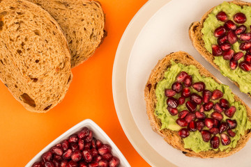 Avocado and Pomegranate Seeds Open Face Sandwich On Mediterranean Bread