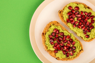 Avocado and Pomegranate Seeds Open Face Sandwich On Mediterranean Bread
