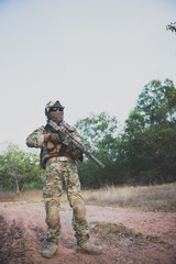 Closeup asian soldier with weapons in hand at the forest,prepare for maneuver,military veterans concept,Thailand army
