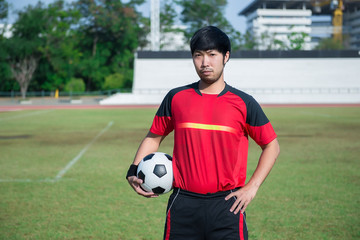 Portrait of asian soccer player before big match in the field,Thailand people