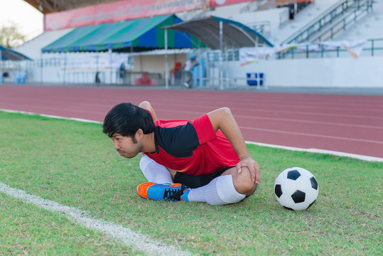 Portrait of asian soccer player warm up before big match in the field,Thailand people - Powered by Adobe