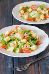 Caesar salad with shrimps, cherry tomato, croutons, salad leaf and parmesan cheese