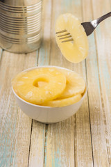 Canned pineapple rings. Ananas slices in a white bowl