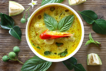Top view of green curry fish ball (Thai food) in white plate on wood table, look delicious.