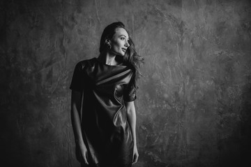 Naklejka premium Portrait of a beautiful pretty woman. Girl has dark, brown hair, a brunette. Serious face in sweatshirt and fashion makeup.