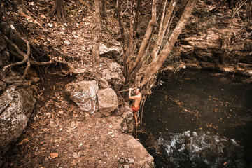 Man swimming in natural Cenote in Mexico