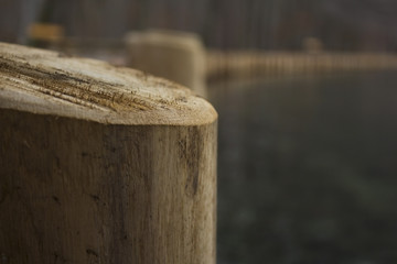 Wooden poles by the lake shore on a cold day