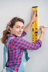 young smiling woman using spirit level