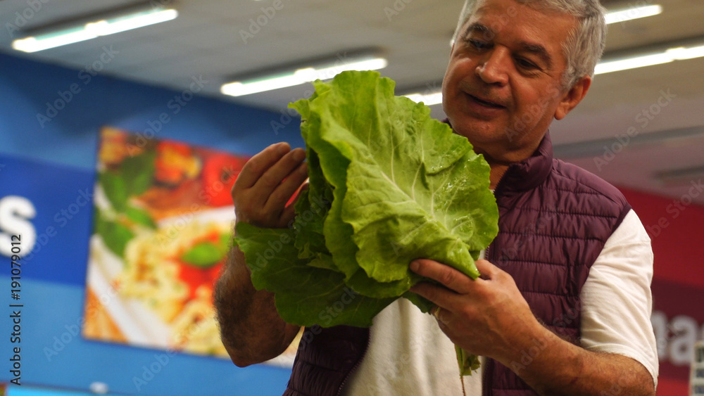 Wall mural Mature Man Showing Cabbage