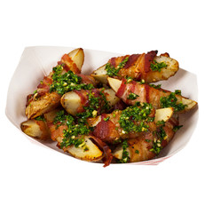 Bacon Wrapped Potatoes Wedges with Parsley Garlic Pesto Sauce Isolated on White background. Selective focus.