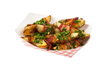 Bacon Wrapped Potatoes Wedges with Parsley Garlic Pesto Sauce Isolated on White background. Selective focus.