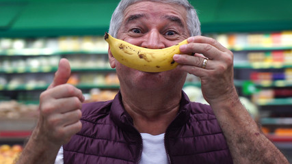 Senior Man Smiling With Banana