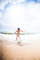 A girl is jumping on the beach.