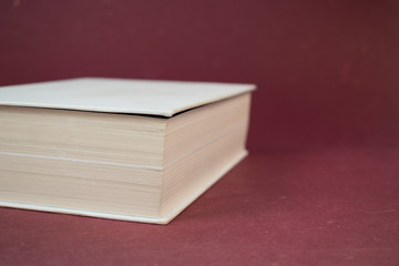 White blank hardcover book on red background