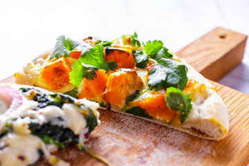 White pizza with pumpkin and cilantro. Italian Cuisine