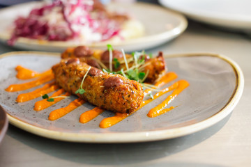 Fried peppers stuffed with cheese on a gray plate
