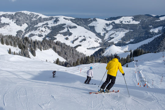 Skier starts his journey in winter, with mountains in switzerland