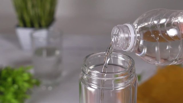 Slow motion. pure drinking water is poured into a glass beaker. HD