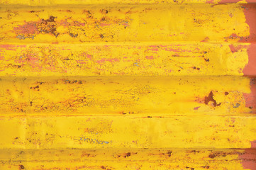 Yellow sea freight container background rusty corrugated pattern, horizontal rusted detailed steel texture cracked grungy metal paint detail, old aged weathered textured rust grunge copy space closeup