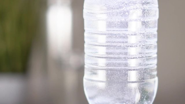 Slow motion. Gas bubbles float in a plastic bottle with drinking water. device for hydrogen rhenium in action. HD